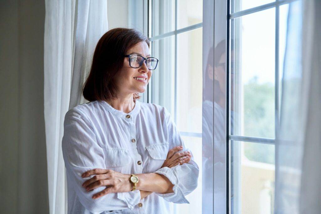 Business middle aged woman looking out the window