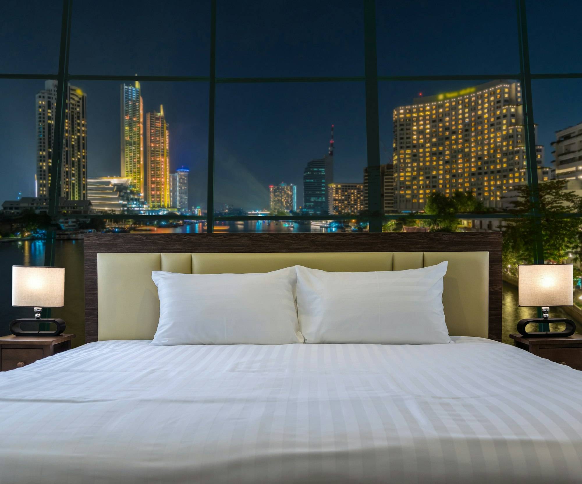 Luxury Interior bedroom with windows glass beside Bangkok Cityscape river side