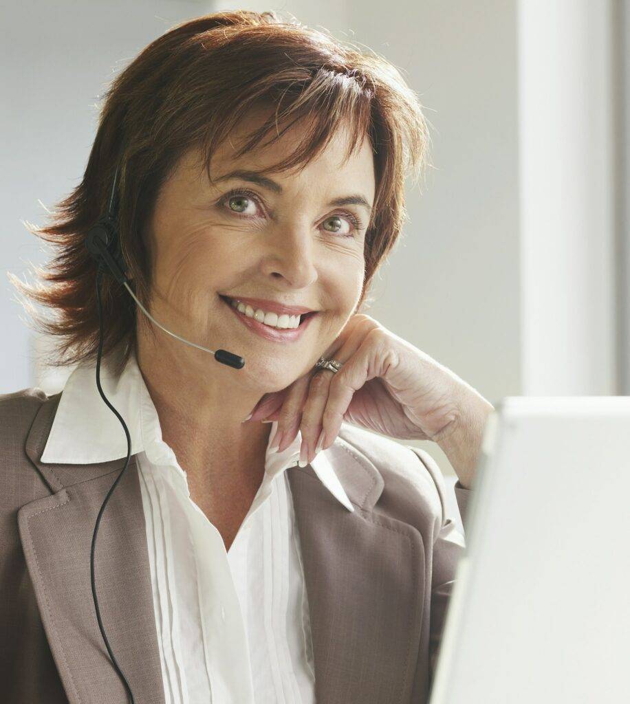 Professional woman with headset smiling at work