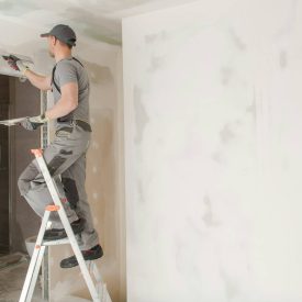 Worker Patching Drywall